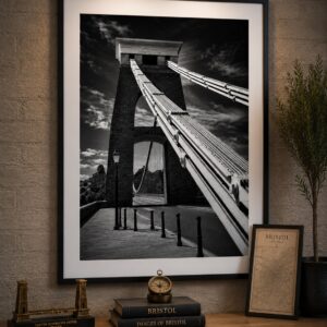 Framed black and white Clifton Suspension Bridge wall art print featuring a dramatic close-up view of the bridge tower and suspension cables.
