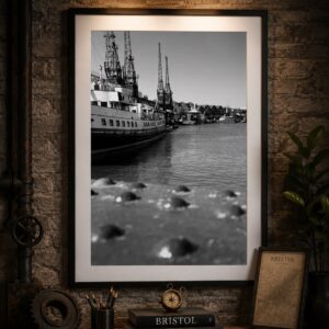 Framed black and white Bristol Harbour wall art print featuring a historic ship and iconic harbour cranes.