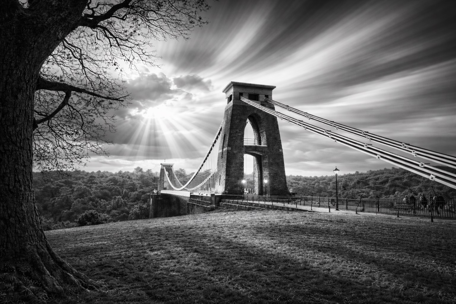 Black and white photograph of Clifton Suspension Bridge with dramatic light